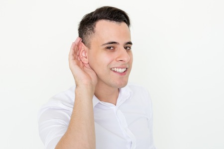 Smiling Attractive Man Holding Hand Near Earの写真素材