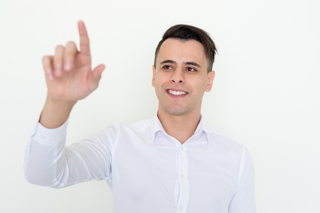 Smiling Attractive Man Touching Invisible Screenの写真素材