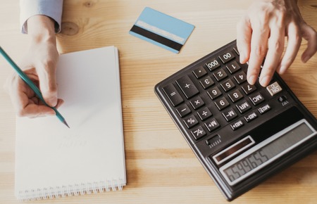 Closeup of Banker with Calculator and Credit Cardの写真素材