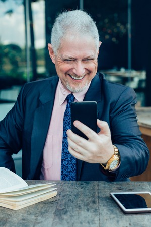 Happy Boss Making Video Call in Street Cafeの写真素材