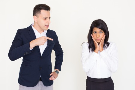 Angry young executive scolding his female employeeの写真素材