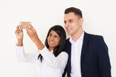 Happy colleagues taking selfie with smartphoneの写真素材