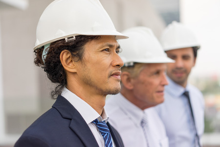 Asian Architect and Coworkers at Construction Siteの写真素材