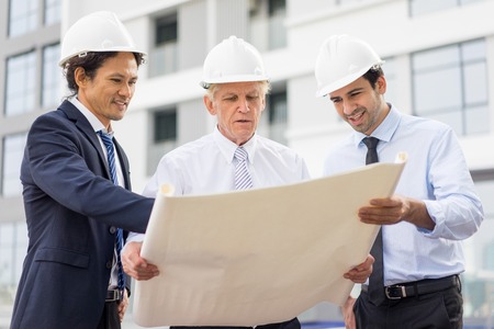 Serious Architects Discussing Project at Site