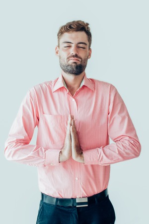 Calm Young Man Meditating with Closed Eyes