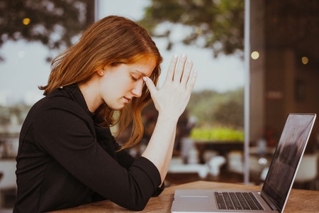 Calm Woman Praying at Outdoor Office Cafeの写真素材