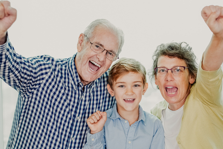 Grandparents and Grandson Showing Winning Gestureの写真素材