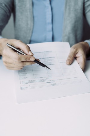 Female lawyer giving contract and pen to client. Close-up of female hands with business items. Agreement conceptの写真素材