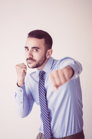 Closeup portrait of office worker brandishing fists during break. Dissatisfied businessman coping with negative emotions. Work balance conceptの写真素材