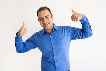 Smiling Indian man showing both thumbs up and looking at camera. Handsome guy advertising something....