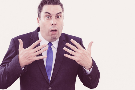 Scared businessman recovering from shock and waving hands to calm down. Puzzled amazed male executive suffering from stress and expressing uncertainty. News conceptの写真素材