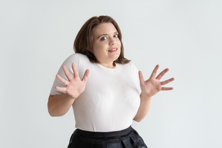 Young woman rejecting to do something. Frightened or surprised girl looking at camera. Facial...