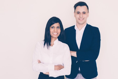 Portrait of successful young multiethnic businessman and businesswoman, Indian woman and North...