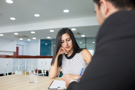 Serious thoughtful business lady listening to colleagues strategy. Pensive woman analyzing information offered by business partner. Discussion conceptの写真素材
