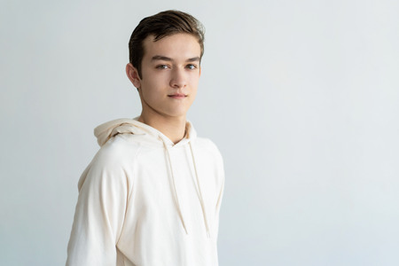 Confident handsome teen boy looking at camera. Young man. Teen boy portrait concept. Isolated view on white background.の写真素材