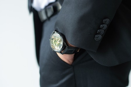 Businessman hand in pants pocket. Closeup of watch on male ceo wrist. Luxury an fashion concept
