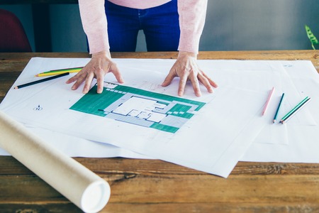 Interior designer studying blueprint. Architect working on floor plan. Architectural design conceptの写真素材