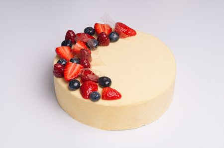 Close-up of appetizing cheesecake with berries. Tasty refreshing cake on white background. Dessert conceptの写真素材