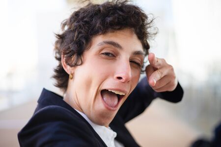 Happy businesswoman pointing at camera. Close-up view of excited middle aged woman pointing with...