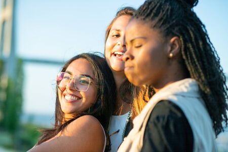 Smiling young women having fun together in park. Happy laughing ladies relaxing in park. Leisure conceptの写真素材