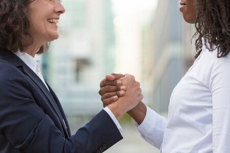 Closeup of friendly handshake. Business women successfully closing deal or project. Partnership and success conceptの写真素材