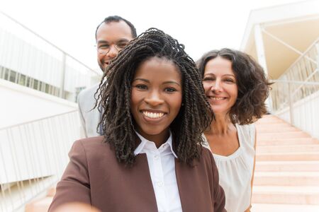 Happy joyful business team celebrating success outside. Business man and women standing near office...