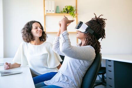 Focused workers testing new device. Concentrated workers setting VR headset. Technology concept