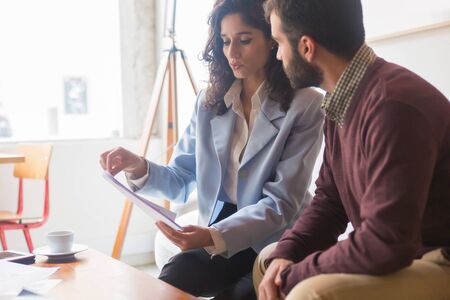 Serious designers choosing color palette. Two planners discussing new project. New house project conceptの写真素材