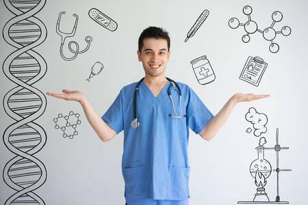 Male doctor holding emptiness with hand drawn medical sketches. Health choice concept. Isolated...