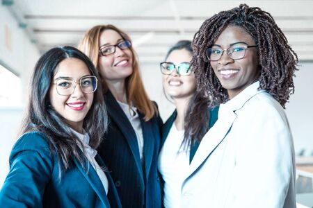 Group of confident young businesswomen looking at camera. Beautiful smiling women posing. Female confidence conceptの写真素材