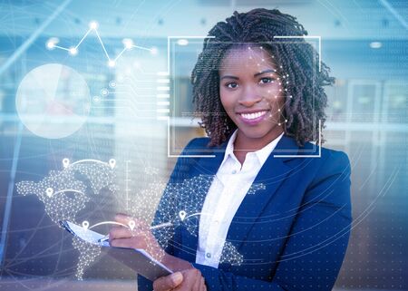 Manager completing survey and virtual identification graphics. Young black business woman standing...