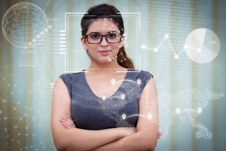 Businesswoman in glasses and virtual identification graphics. Portrait of confident young Caucasian...