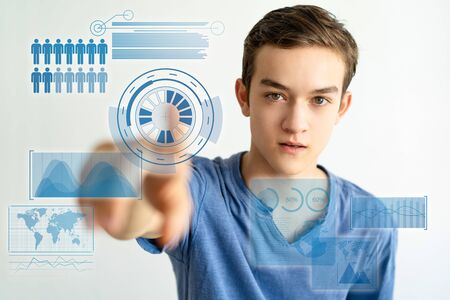 Content curious young man using virtual statistics. Handsome student guy reaching finger to camera. Cyberspace conceptの写真素材