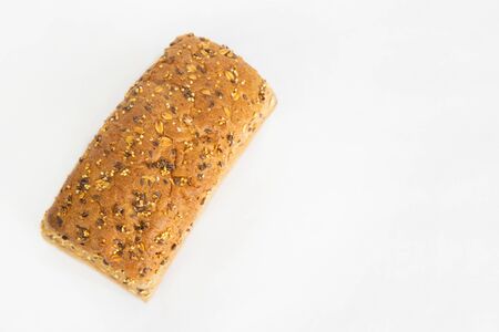 Tasty brick form bread baked at home. Soft whole loaf with cereals, oats, seeds isolated on white...