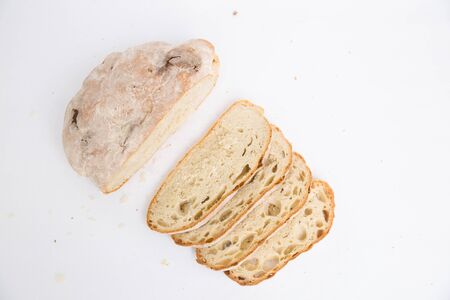 Sliced homemade white bread with breadcrumbs. Top view. Closeup shot. Isolated object on white...