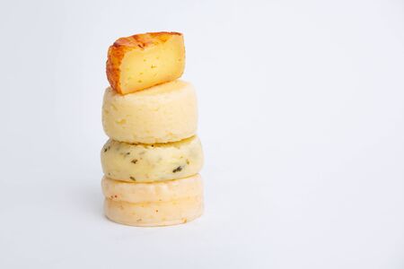 Stack of tasty round chesses isolated on white background. Studio shot. Side view. Dairy food and cooking at home concept for flyers and bannersの写真素材