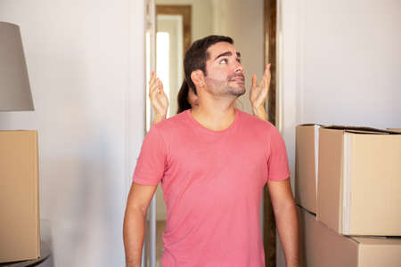 Woman showing new home to surprised excited boyfriend. Medium shot, front view. New home or surprise...