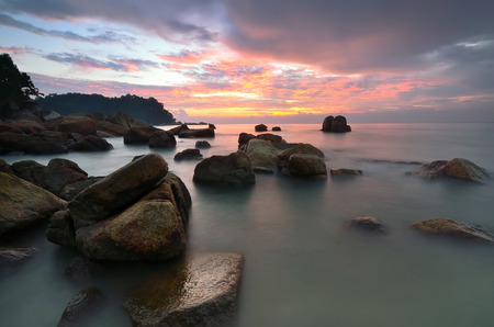 Colorful sunset over the sea at Teluk Cempedak, Kuantan, Pahang, Malaysia.image may contain softness and little grain due to long exposure.の写真素材