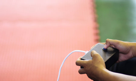Referee gives signal to young Taekwondo athletes with his joystickの写真素材