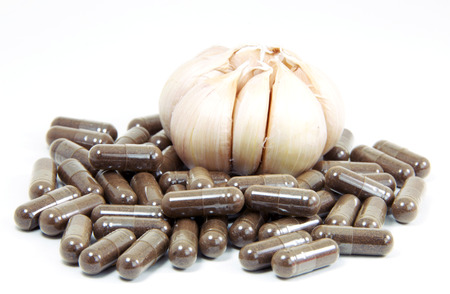 Garlic herbal capsules,oral medicine,alternative medication isolated on white background の写真素材