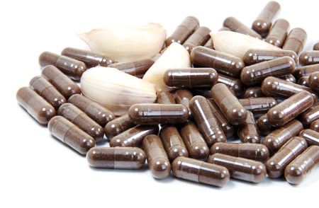 Garlic herbal capsules,oral medicine,alternative medication isolated on white background の写真素材