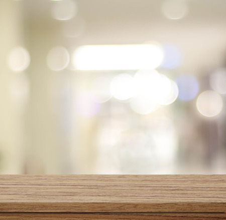 Empty table and blurred store with bokeh background, product display template.