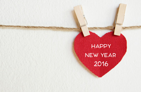 Red fabric heart with happy new year 2016 word hanging on the clothesline, new year templateの写真素材