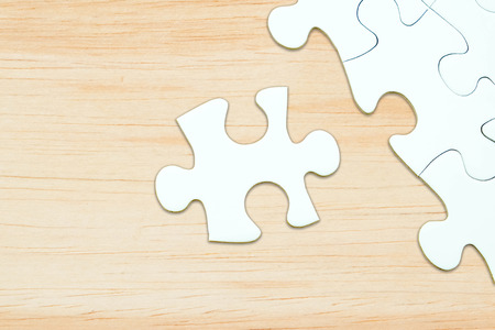 Jigsaw puzzle on wood for business concepts template such as sucess, problem solution, idea, teamwork etc.の写真素材