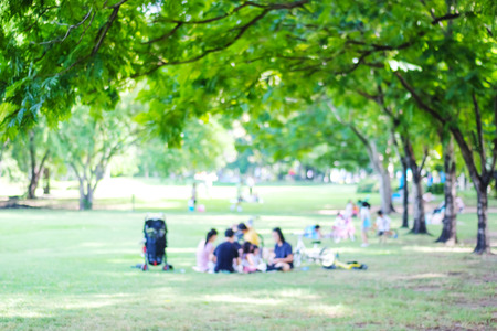 Blurred background of people activities in park with bokeh light, spring and summerの写真素材