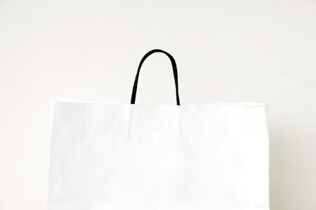 White shopping bag over whie wall background, business, template, retail, saleの写真素材