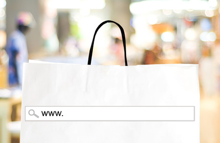 Word www. on search bar over shopping bag and blur store background, online shopping background, business, E-commerce, web bannerの写真素材