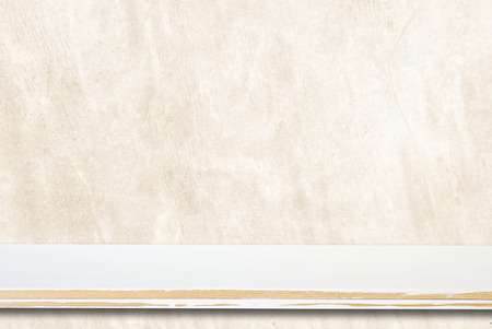 Empty white wooden table over grunge brown cement wallの写真素材