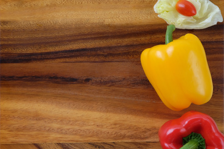 Bell peppers, tomatoes and cabbage on wood background, organic vegetable, flat layの写真素材