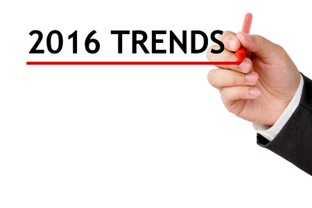 Hand holding pen and 2016 trends on white background with copy space, business conceptの写真素材